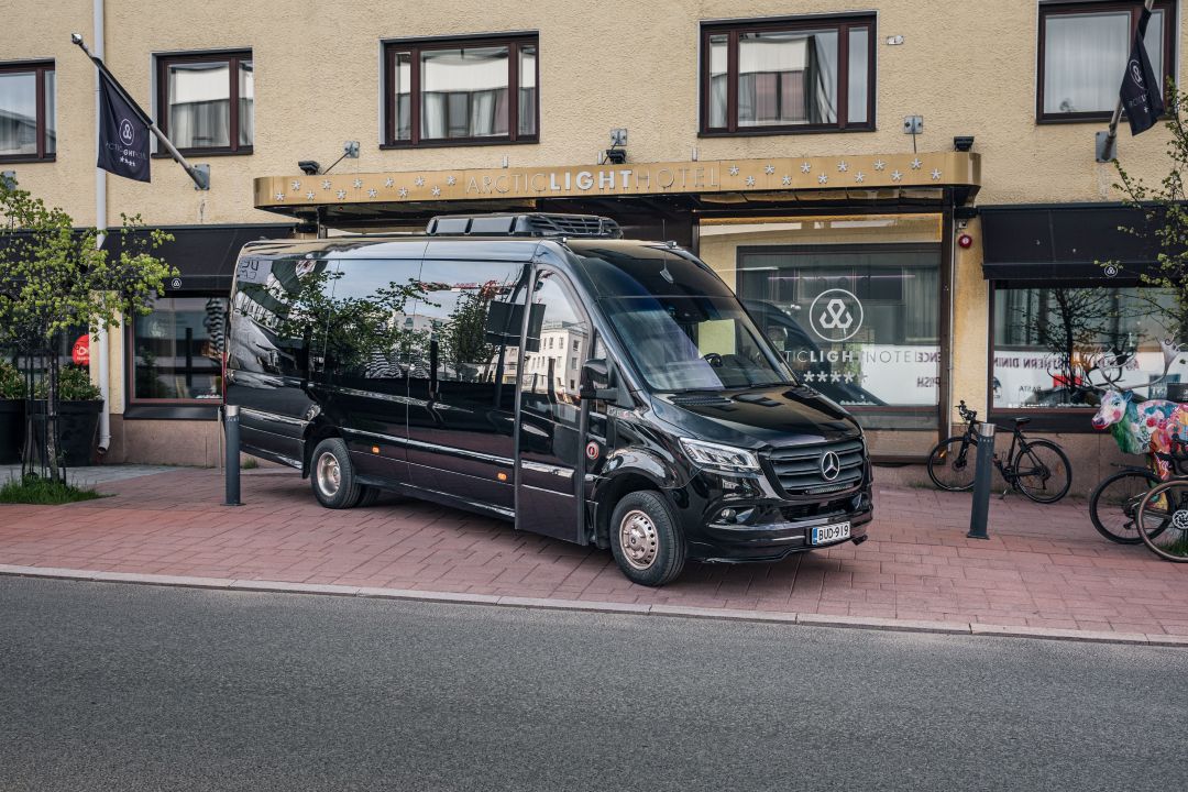 The 16-seat Vulpes Aurora van outside a hotel pickup in central Rovaniemi.