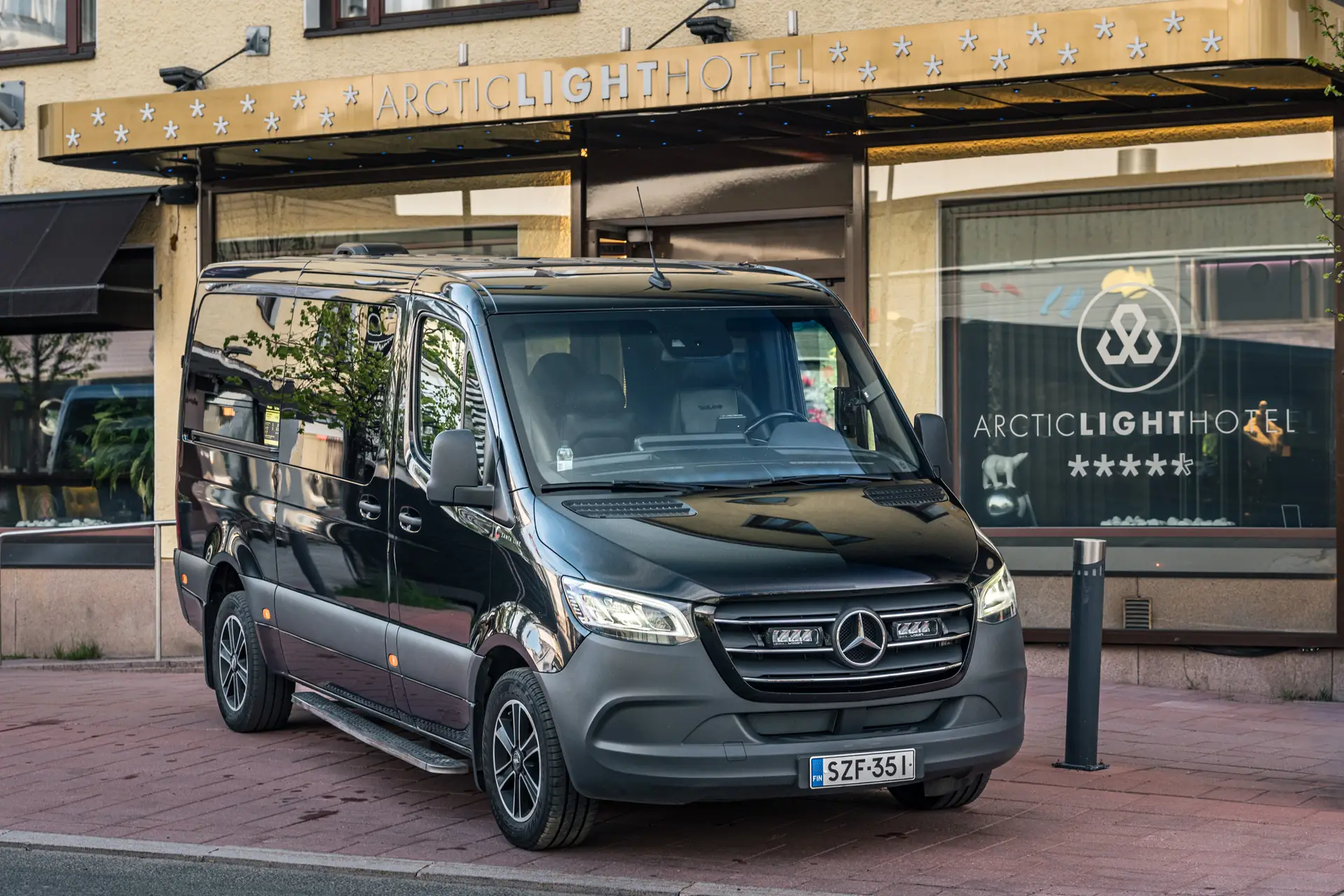 The 8-seat van parked in front of the Arctic Light Hotel in Rovaniemi.