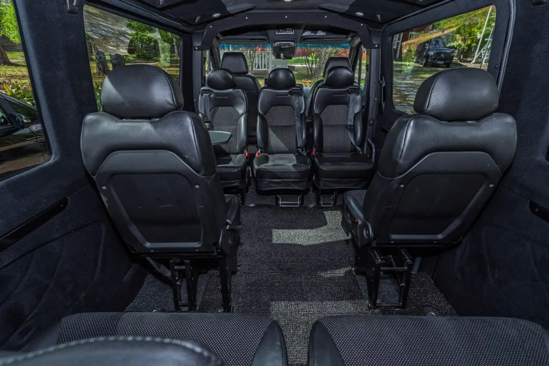 Inside the 8-seat van: leather seats with room to breathe.