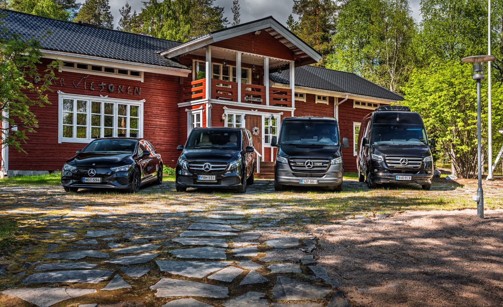 Four black Mercedes vehicles of the Vulpes Aurora family fleet lined up in Lapland.